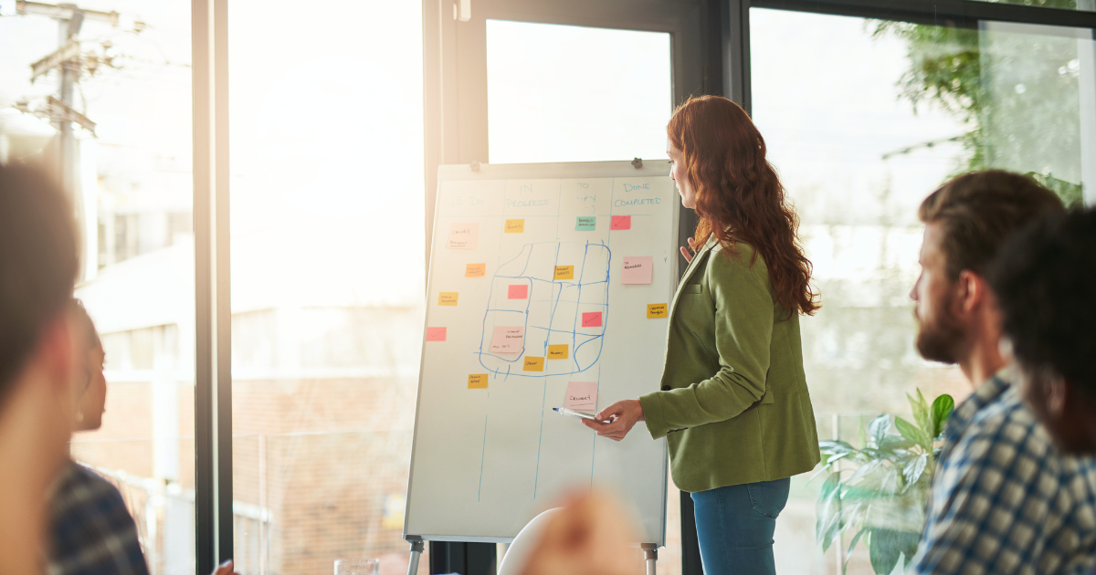 Team meeting with woman presenting strategy to avoid Video Marketing Mistakes Tech Brands Make