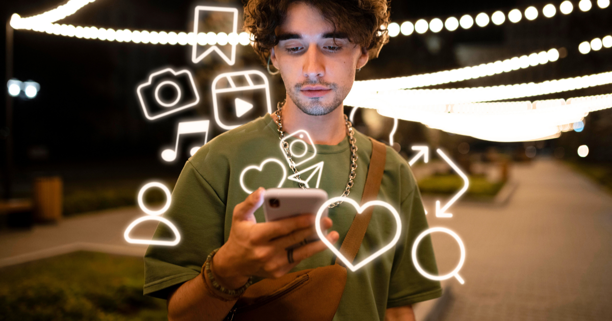 A person holding a smartphone surrounded by floating social media icons.