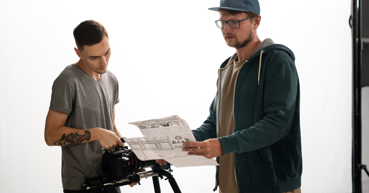 Two video creators discussing a storyboard on set and how AI + Video: Transforming Tech Brand Storytelling