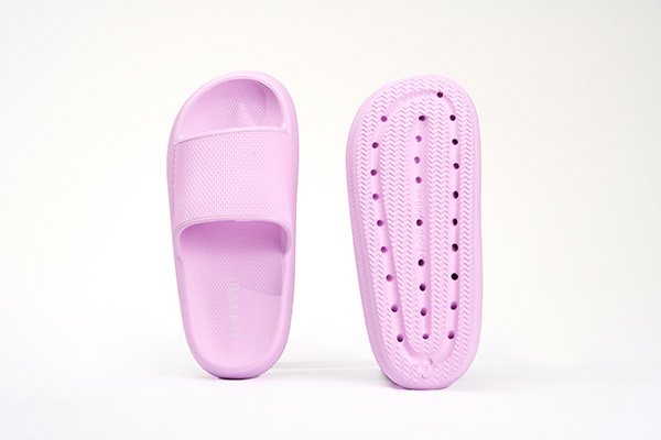 Light pink slide sandal with top and sole views.