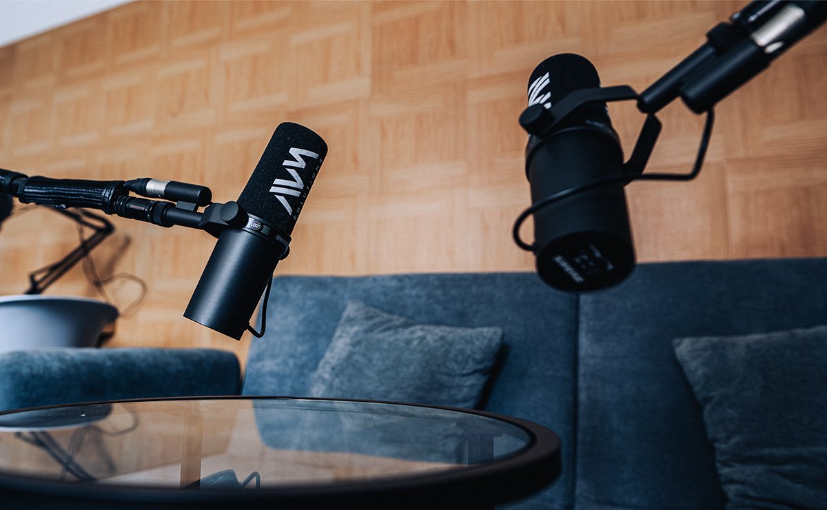 Close-up of podcast microphones set up in a recording space.