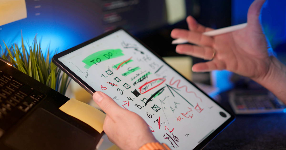 Filmmaker planning production tasks digitally to reduce paper waste and improve sustainability