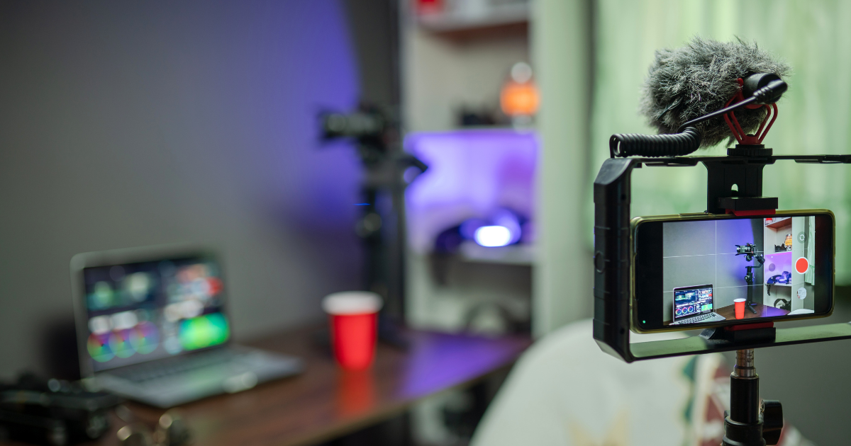 Livestream host using microphone and headphones in a home studio