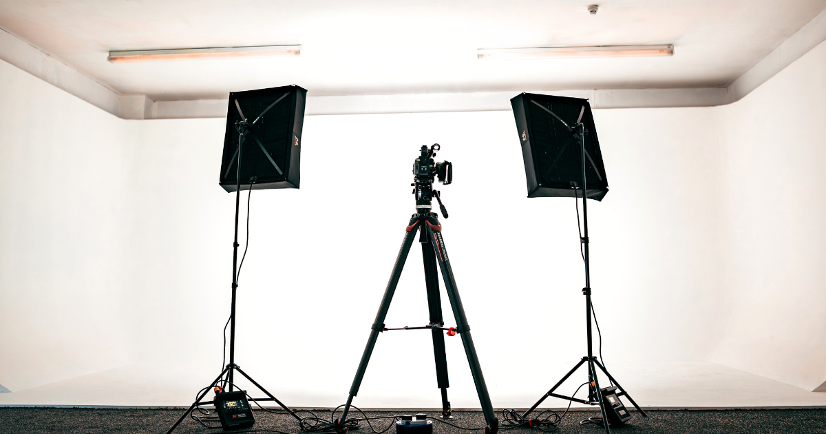 Small studio lighting setup with camera and softbox lights for professional video production by Title Productions.