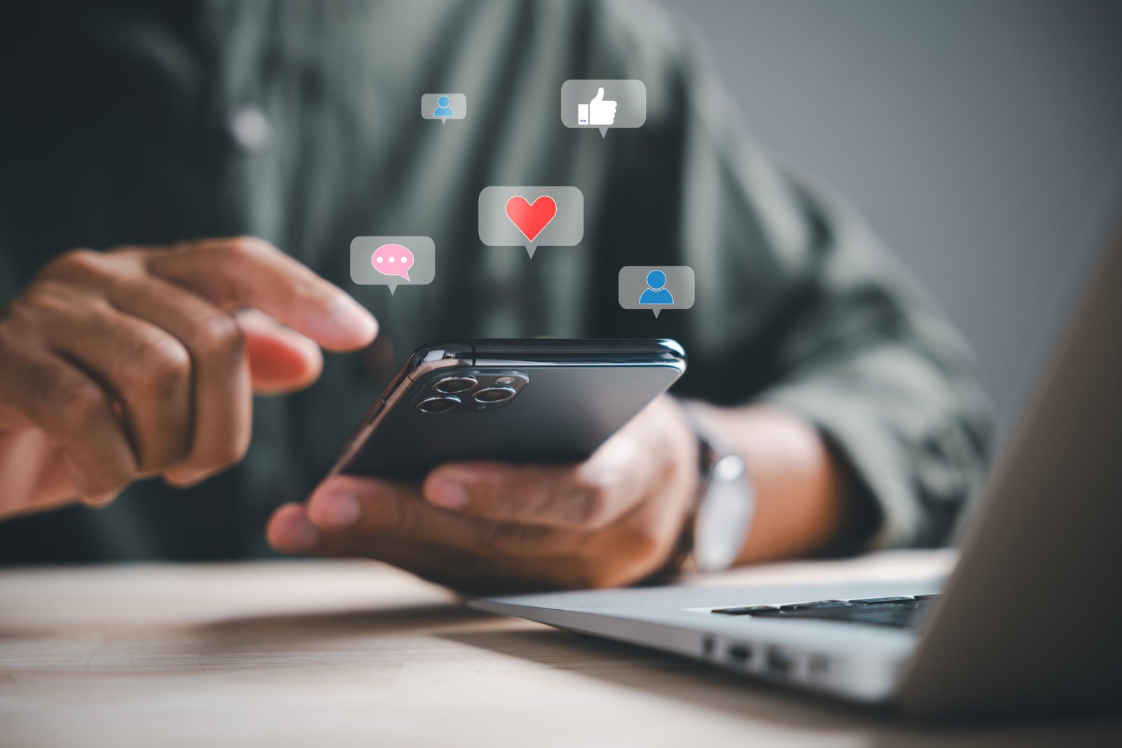 Smartphone displaying social media engagement icons representing Title Productions social media marketing strategy.